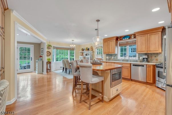 Chandelier, Dining room, Interior, Kitchen, Pendant Lights, Recessed Lighting, Stainless Steel Appliances, Wood Texture Flooring