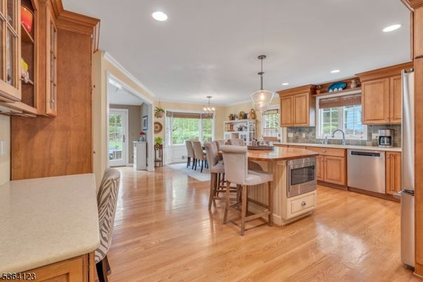 Chandelier, Dining room, Interior, Kitchen, Pendant Lights, Recessed Lighting, Stainless Steel Appliances, Wood Texture Flooring