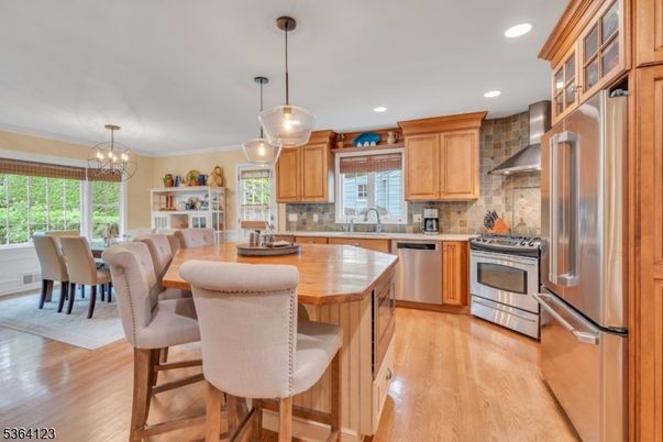 Chandelier, Dining room, Interior, Kitchen, Pendant Lights, Recessed Lighting, Stainless Steel Appliances, Wood Texture Flooring