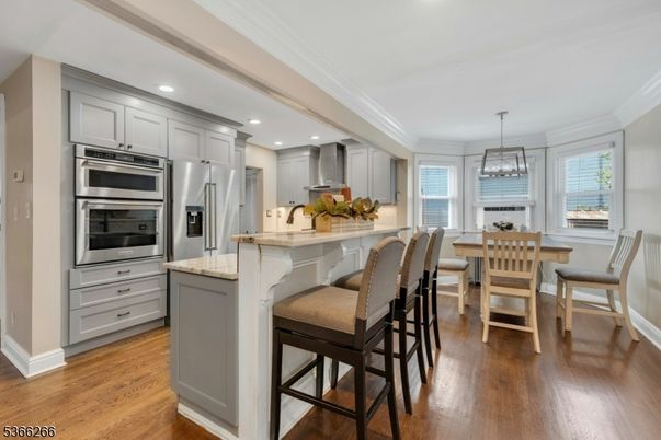 Chandelier, Dining room, Interior, Kitchen, Recessed Lighting, Stainless Steel Appliances, Wood Texture Flooring