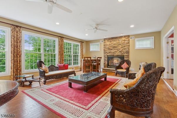 Dining room, Fireplace, Interior, Living room, Recessed Lighting, Stone Walls, Wood Texture Flooring