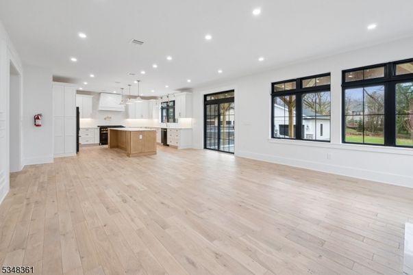Empty room, Interior, Kitchen, Pendant Lights, Recessed Lighting, Stainless Steel Appliances, Wood Texture Flooring