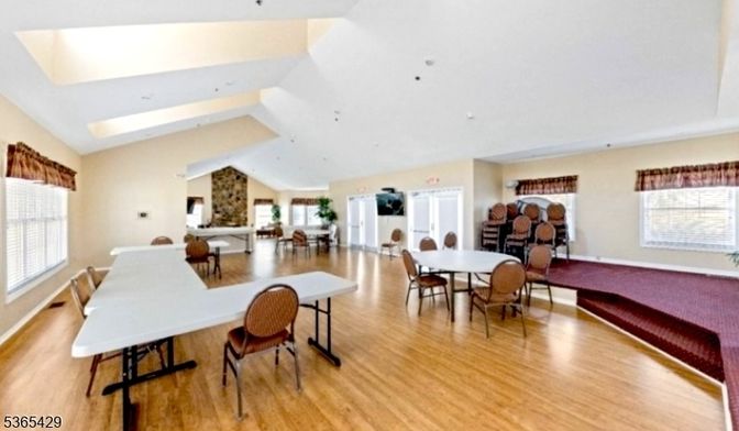 Dining room, Fireplace, Interior, Recessed Lighting, Stone Walls, Wood Texture Flooring