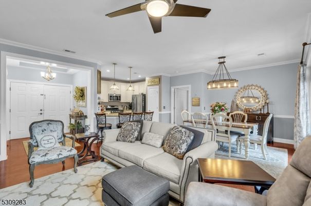 Chandelier, Dining room, Interior, Kitchen, Living room, Pendant Lights, Recessed Lighting, Stainless Steel Appliances, Wood Texture Flooring