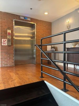Elevator, Interior, Recessed Lighting, Stone Walls, Wood Texture Flooring