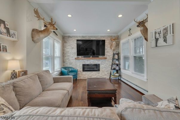 Fireplace, Interior, Living room, Recessed Lighting, Stone Walls, Wood Texture Flooring
