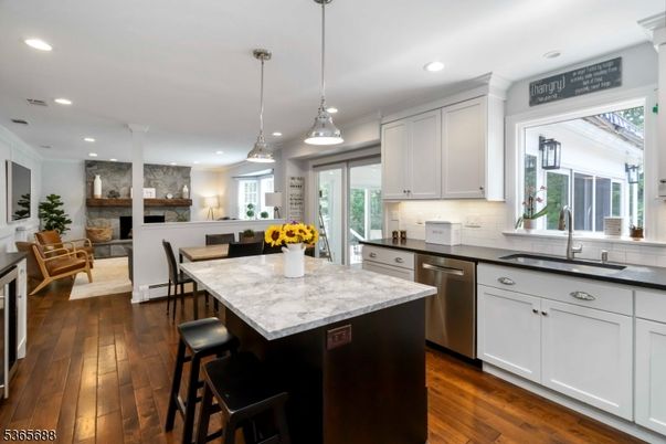 Dining room, Fireplace, Interior, Kitchen, Pendant Lights, Recessed Lighting, Stainless Steel Appliances, Wood Texture Flooring
