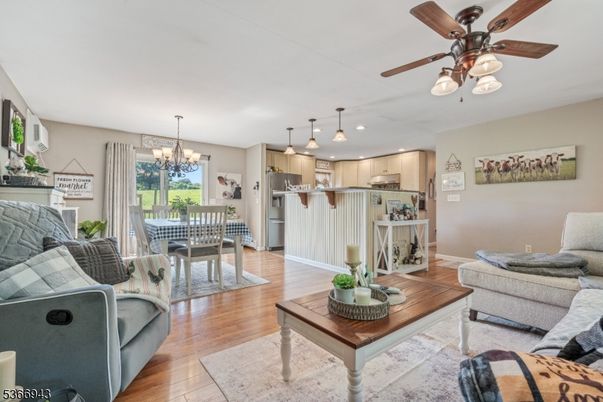 Chandelier, Dining room, Interior, Kitchen, Living room, Pendant Lights, Recessed Lighting, Stainless Steel Appliances, Wood Texture Flooring
