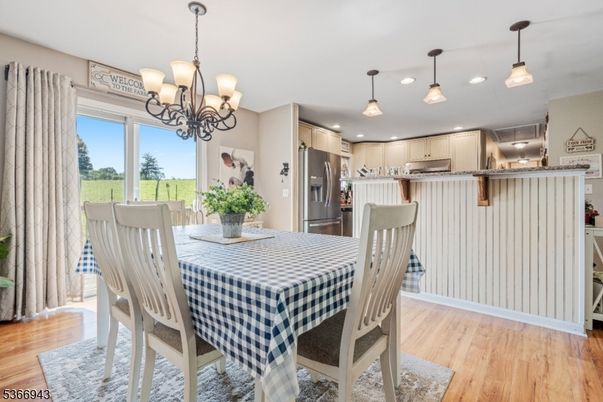 Chandelier, Dining room, Interior, Kitchen, Pendant Lights, Recessed Lighting, Stainless Steel Appliances, Wood Texture Flooring