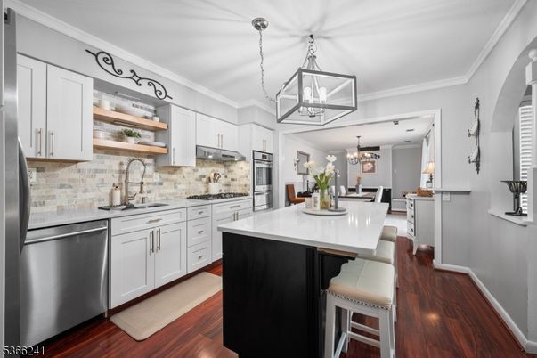 Chandelier, Dining room, Interior, Kitchen, Pendant Lights, Stainless Steel Appliances, Wood Texture Flooring