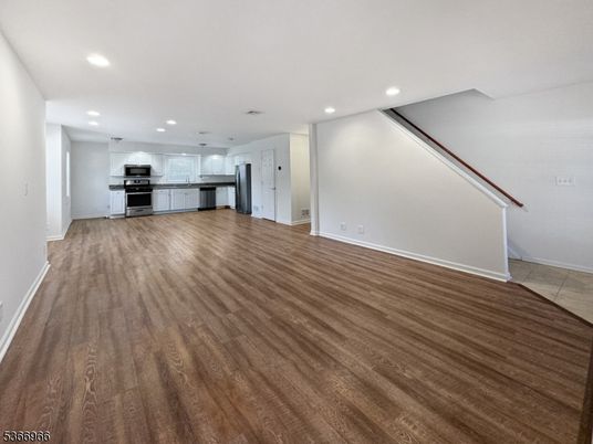 Empty room, Interior, Kitchen, Recessed Lighting, Stainless Steel Appliances, Wood Texture Flooring