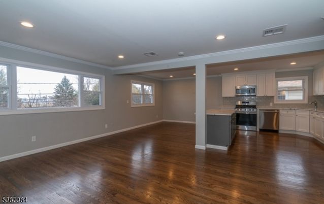 Empty room, Interior, Kitchen, Recessed Lighting, Stainless Steel Appliances, Wood Texture Flooring