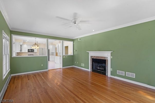 Chandelier, Empty room, Fireplace, Interior, Kitchen, Recessed Lighting, Wood Texture Flooring