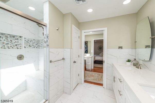 Bathroom, Dual Sink Vanities, Glass Shower, Interior, Marble, Marble Walls, Recessed Lighting, Wood Texture Flooring