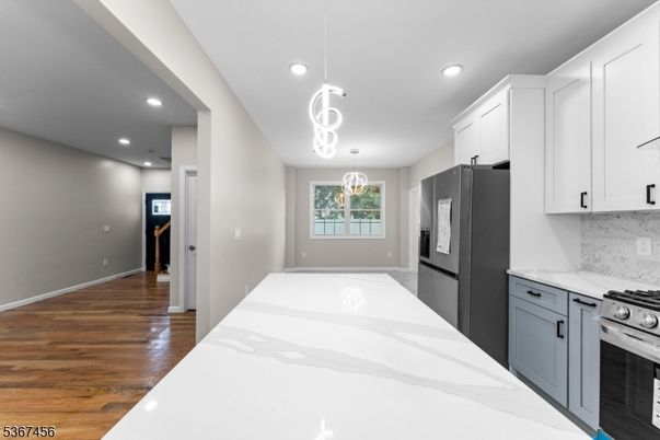 Interior, Kitchen, Marble Walls, Pendant Lights, Recessed Lighting, Stainless Steel Appliances, Wood Texture Flooring
