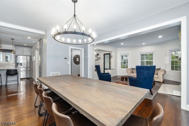 Chandelier, Dining room, Interior, Kitchen, Living room, Pendant Lights, Recessed Lighting, Stainless Steel Appliances, Wood Texture Flooring