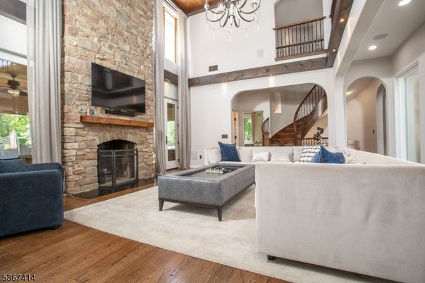 Chandelier, Fireplace, Interior, Living room, Recessed Lighting, Stone Walls, Wood Texture Flooring