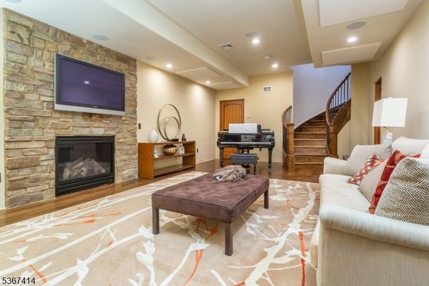 Fireplace, Interior, Living room, Piano, Recessed Lighting, Stone Walls, Wood Texture Flooring