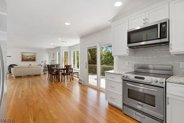 Dining room, Interior, Kitchen, Living room, Recessed Lighting, Stainless Steel Appliances, Wood Texture Flooring