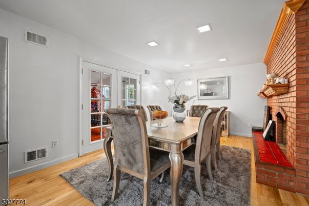Dining room, Fireplace, Interior, Recessed Lighting, Stone Walls, Wood Texture Flooring