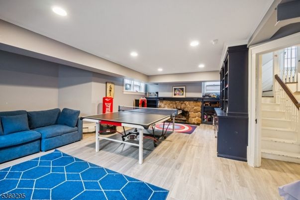 Fireplace, Game Room, Interior, Recessed Lighting, Wood Texture Flooring