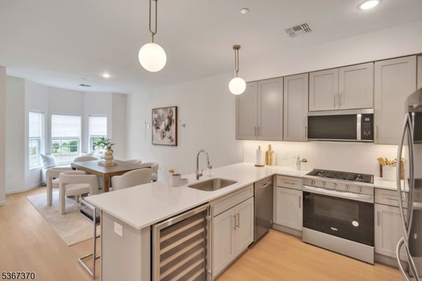 Dining room, Interior, Kitchen, Pendant Lights, Recessed Lighting, Stainless Steel Appliances, Wood Texture Flooring