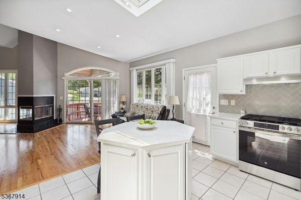 Dining room, Fireplace, Interior, Kitchen, Recessed Lighting, Stainless Steel Appliances, Wood Texture Flooring