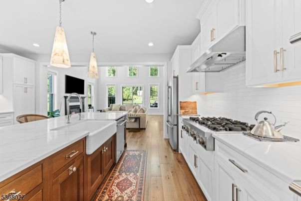 Fireplace, Interior, Kitchen, Living room, Pendant Lights, Recessed Lighting, Stainless Steel Appliances, Wood Texture Flooring