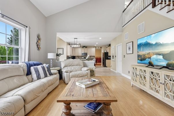 Chandelier, Interior, Kitchen, Living room, Pendant Lights, Recessed Lighting, Stainless Steel Appliances, Wood Texture Flooring