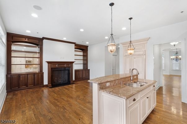 Chandelier, Empty room, Fireplace, Interior, Kitchen, Pendant Lights, Recessed Lighting, Wood Texture Flooring