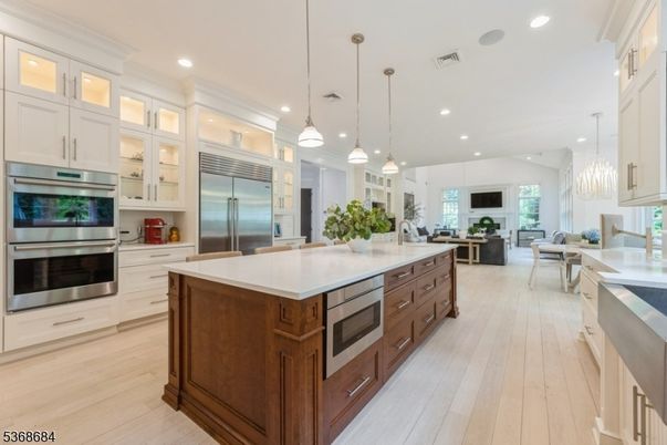 Fireplace, Interior, Kitchen, Living room, Pendant Lights, Recessed Lighting, Stainless Steel Appliances, Wood Texture Flooring