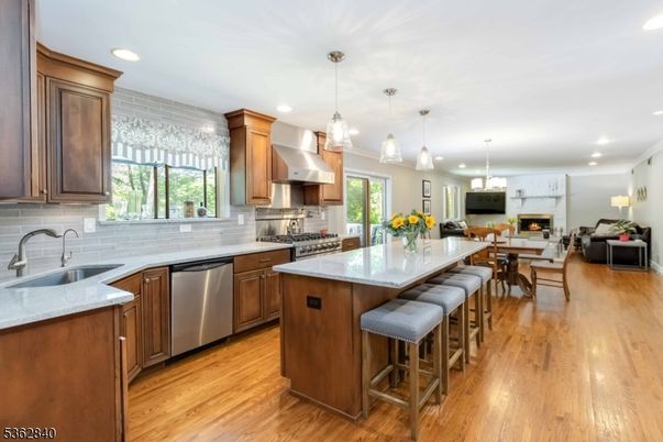 Dining room, Fireplace, Interior, Kitchen, Living room, Pendant Lights, Recessed Lighting, Stainless Steel Appliances, Wood Texture Flooring