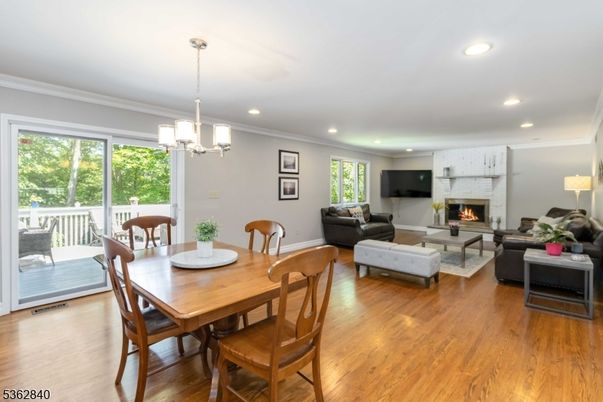 Chandelier, Dining room, Fireplace, Interior, Living room, Pendant Lights, Recessed Lighting, Wood Texture Flooring