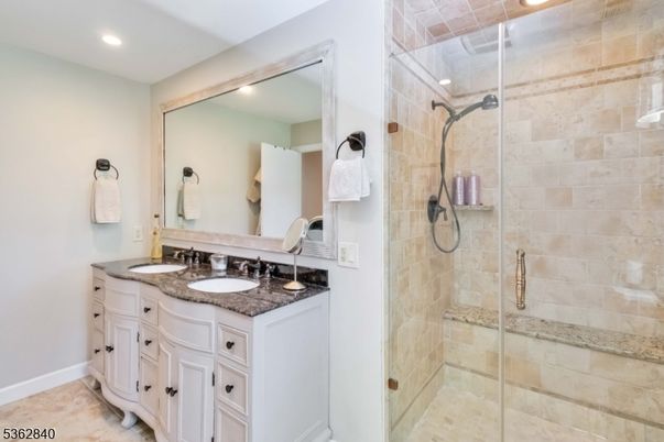 Bathroom, Dual Sink Vanities, Glass Shower, Interior, Recessed Lighting, Stone Walls