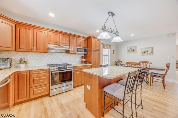 Dining room, Interior, Kitchen, Pendant Lights, Recessed Lighting, Stainless Steel Appliances, Wood Texture Flooring