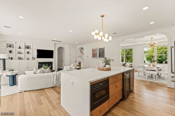 Chandelier, Dining room, Fireplace, Interior, Kitchen, Living room, Pendant Lights, Recessed Lighting, Wood Texture Flooring