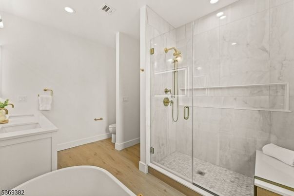Bathroom, Glass Shower, Interior, Marble Walls, Recessed Lighting, Wood Texture Flooring