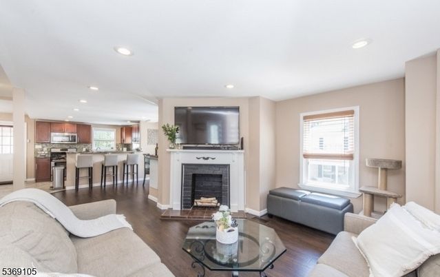 Fireplace, Interior, Kitchen, Living room, Recessed Lighting, Stainless Steel Appliances, Wood Texture Flooring