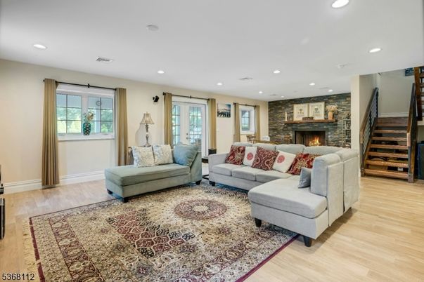 Fireplace, Interior, Living room, Recessed Lighting, Stone Walls, Wood Texture Flooring
