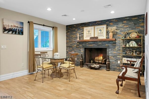 Dining room, Fireplace, Interior, Recessed Lighting, Stone Walls, Wood Texture Flooring