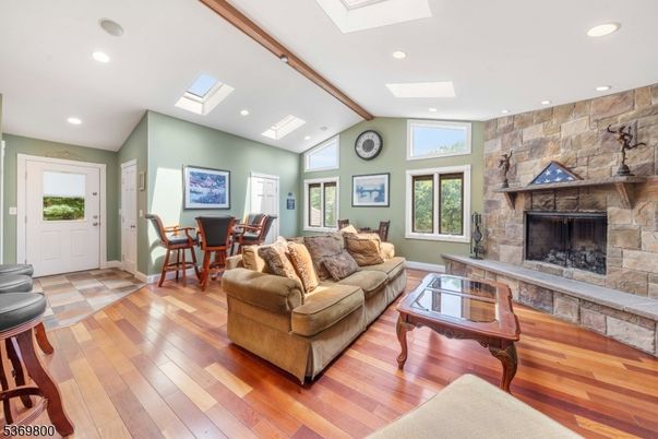 Dining room, Fireplace, Interior, Living room, Recessed Lighting, Stone Walls, Wood Texture Flooring