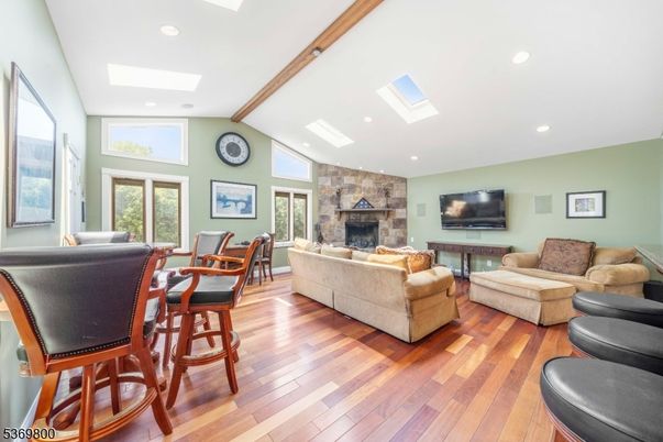 Dining room, Fireplace, Interior, Living room, Recessed Lighting, Stone Walls, Wood Texture Flooring
