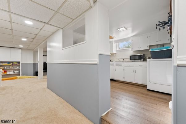 Interior, Kitchen, Recessed Lighting, Washer, Wood Texture Flooring