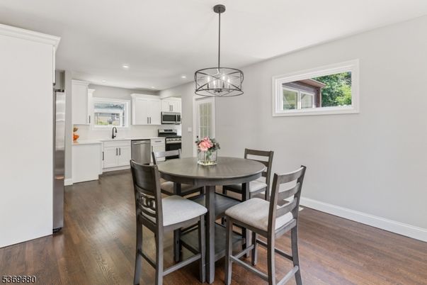 Chandelier, Dining room, Interior, Kitchen, Pendant Lights, Recessed Lighting, Stainless Steel Appliances, Wood Texture Flooring