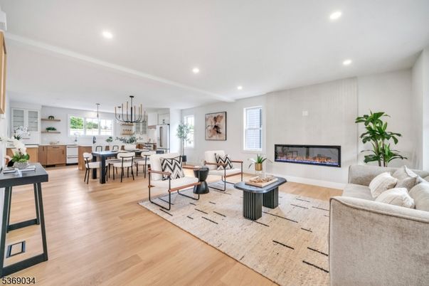 Chandelier, Dining room, Fireplace, Interior, Living room, Pendant Lights, Recessed Lighting, Wood Texture Flooring