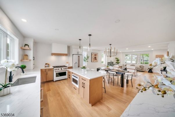 Chandelier, Dining room, Interior, Kitchen, Living room, Pendant Lights, Recessed Lighting, Stainless Steel Appliances, Wood Texture Flooring