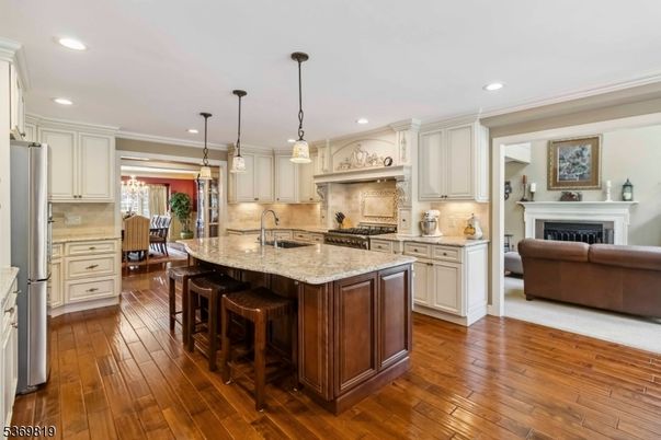 Dining room, Fireplace, Interior, Kitchen, Living room, Pendant Lights, Recessed Lighting, Stainless Steel Appliances, Wood Texture Flooring
