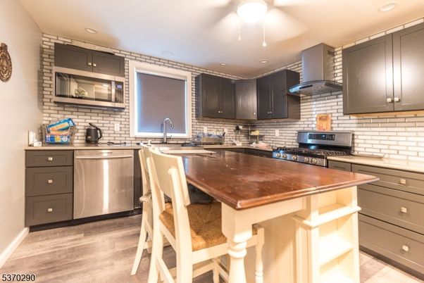Interior, Kitchen, Recessed Lighting, Stainless Steel Appliances, Stone Walls, Wood Texture Flooring