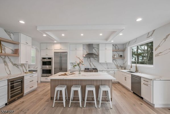Interior, Kitchen, Marble Walls, Recessed Lighting, Stainless Steel Appliances, Wood Texture Flooring