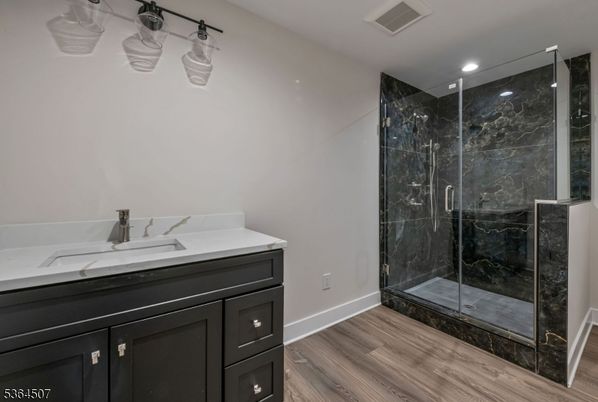 Bathroom, Glass Shower, Interior, Marble Walls, Recessed Lighting, Wood Texture Flooring